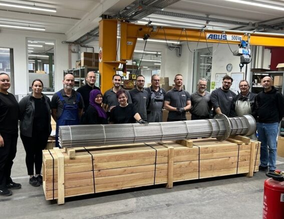 HELIOS employees with a flanged heating element
