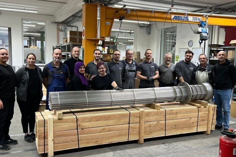 HELIOS employees with a flanged heating element